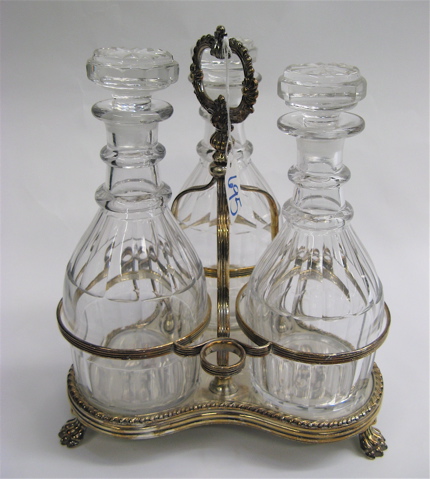 Appraisal: SILVER PLATED THREE-BOTTLE TANTALUS an ornate stand with floral decorated