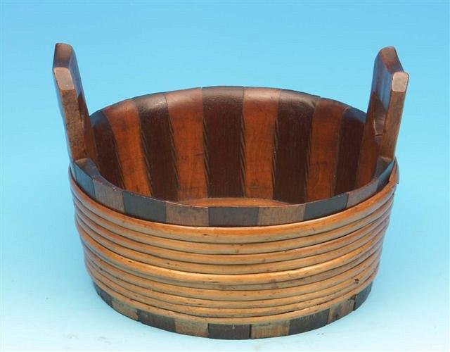 Appraisal: A continental walnut maple wood and hazel tied dairy bowl