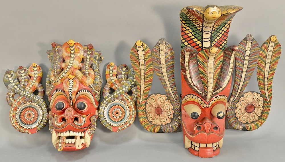 Appraisal: Two carved wood painted cobra snake headdress mask having intertwined