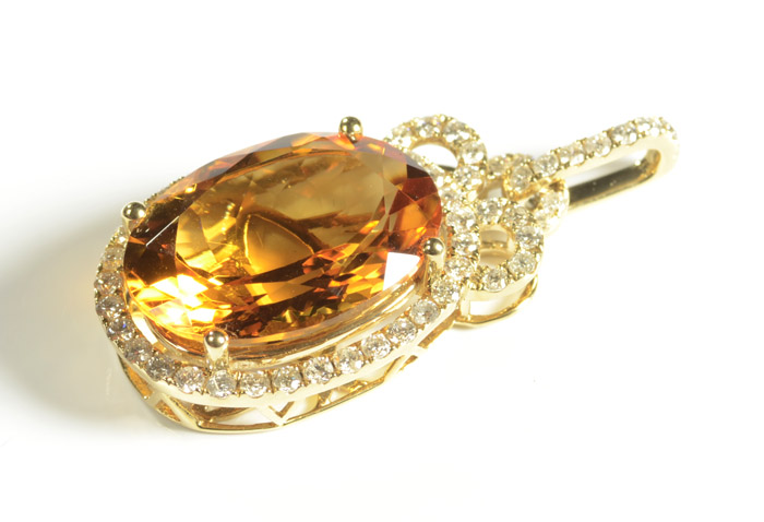 Appraisal: CITRINE AND FOURTEEN KARAT GOLD PENDANT with round-cut diamonds set