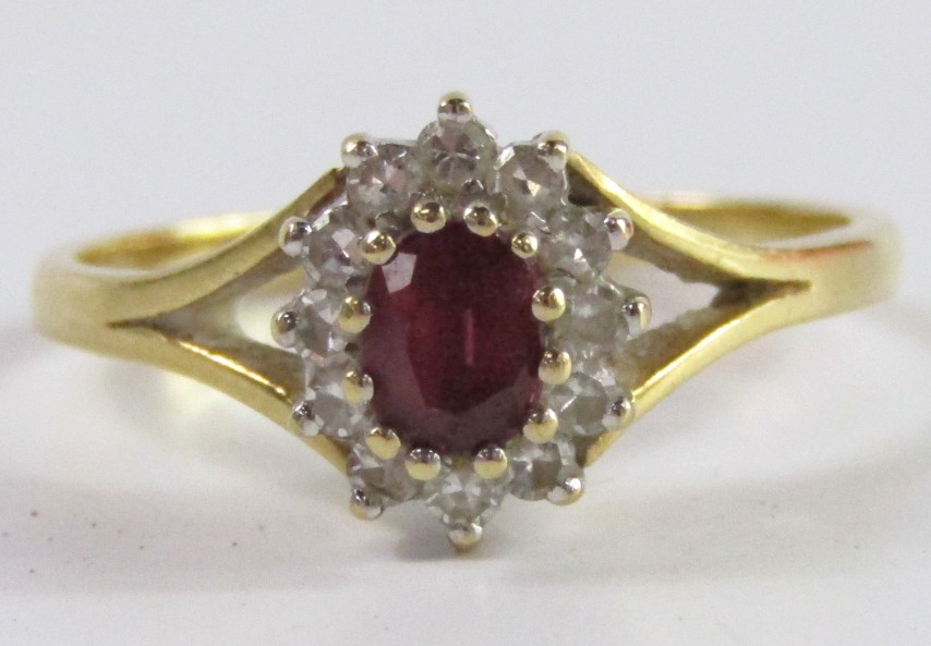 Appraisal: A ruby and diamond oval cluster ring set in ct