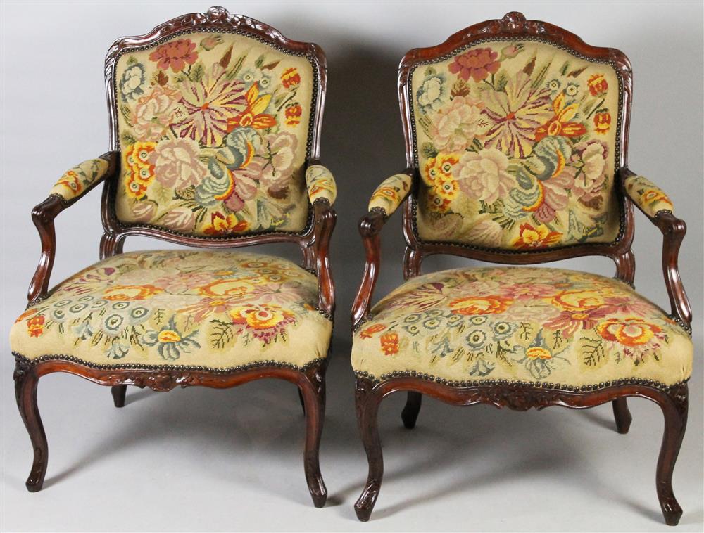 Appraisal: PAIR OF CARVED WALNUT LOUIS XV STYLE ARM CHAIRS IN