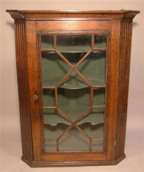 Appraisal: GEORGE III OAK HANGING CORNER CABINET the molded cornice over