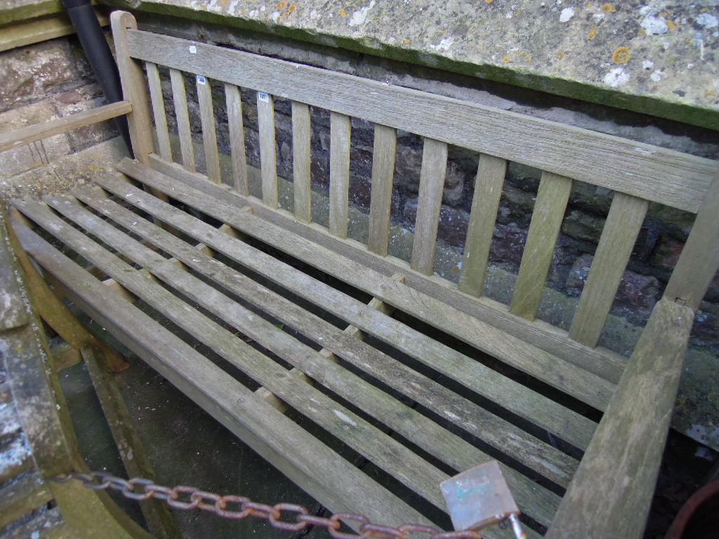 Appraisal: A weathered timber garden bench with slatted seat and back