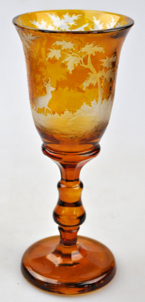 Appraisal: A Bohemian amber flash glass goblet decorated with a deer