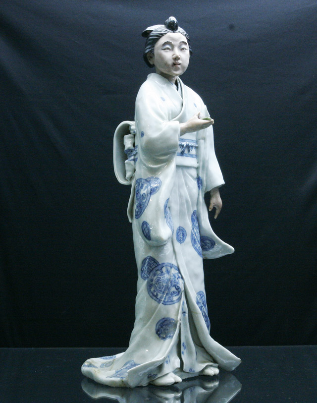 Appraisal: A Japanese ceramic figure of a woman cms high