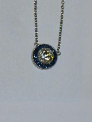 Appraisal: A DIAMOND AND SAPPHIRE PENDANT comprising central diamond approximately cts