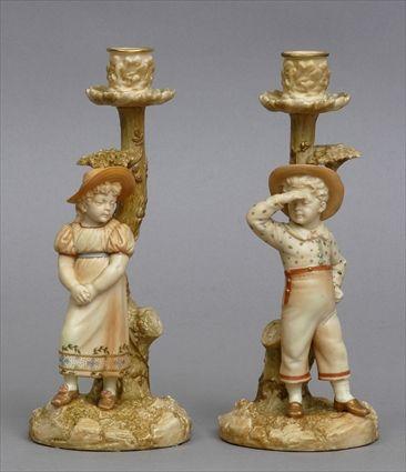 Appraisal: PAIR OF ROYAL WORCESTER PORCELAIN AESTHETIC MOVEMENT FIGURAL CANDLESTICKS Modeled