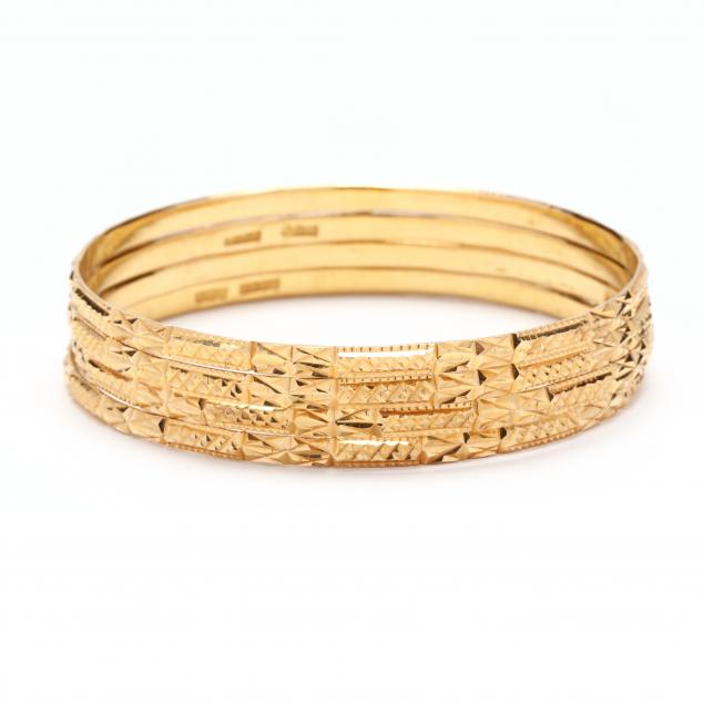 Appraisal: A Set of Four Gold Bangles India With dye cut