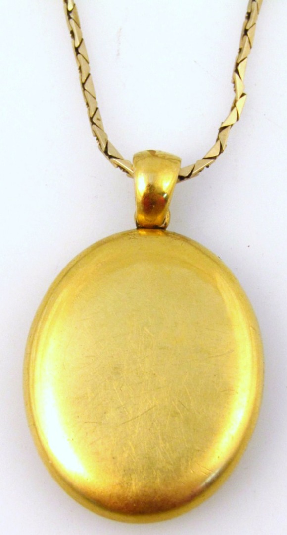 Appraisal: An Edwardian yellow metal locket of oval outline with hook