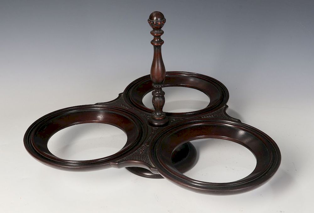 Appraisal: A SCOTTISH MAHOGANY REVOLVING PLATE STAND C A carved mahogany