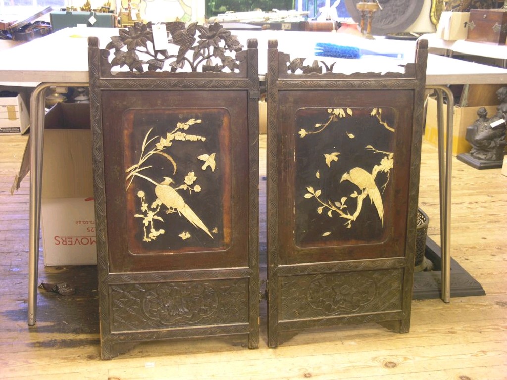 Appraisal: A Japanese carved hardwood screen hinged in two sections each