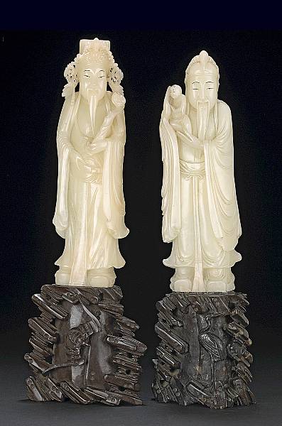 Appraisal: A pair of white and brown soapstone carvings of Daoist