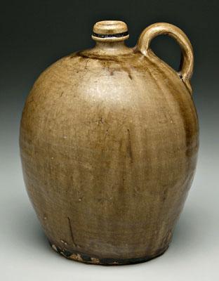 Appraisal: Edgefield pottery ovoid jug applied strap handle runny olive alkaline