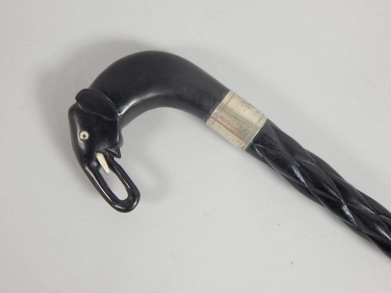 Appraisal: A thC African ebony walking stick the handle carved in