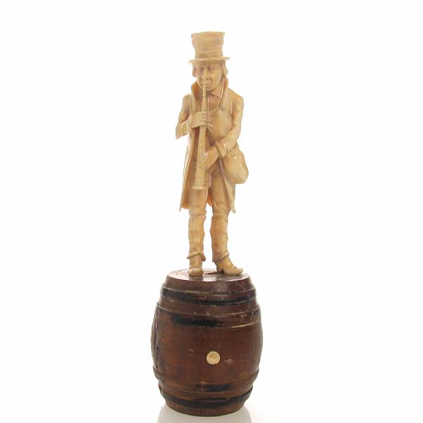 Appraisal: A German carved ivory figure of a musician on a