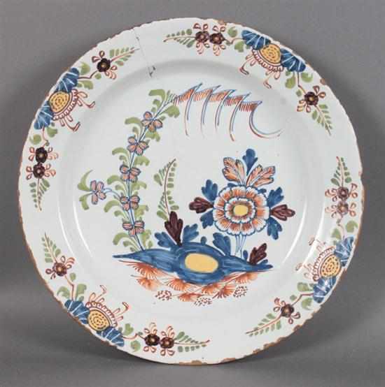 Appraisal: English polychrome Delftware charger circa floral decorated border and center