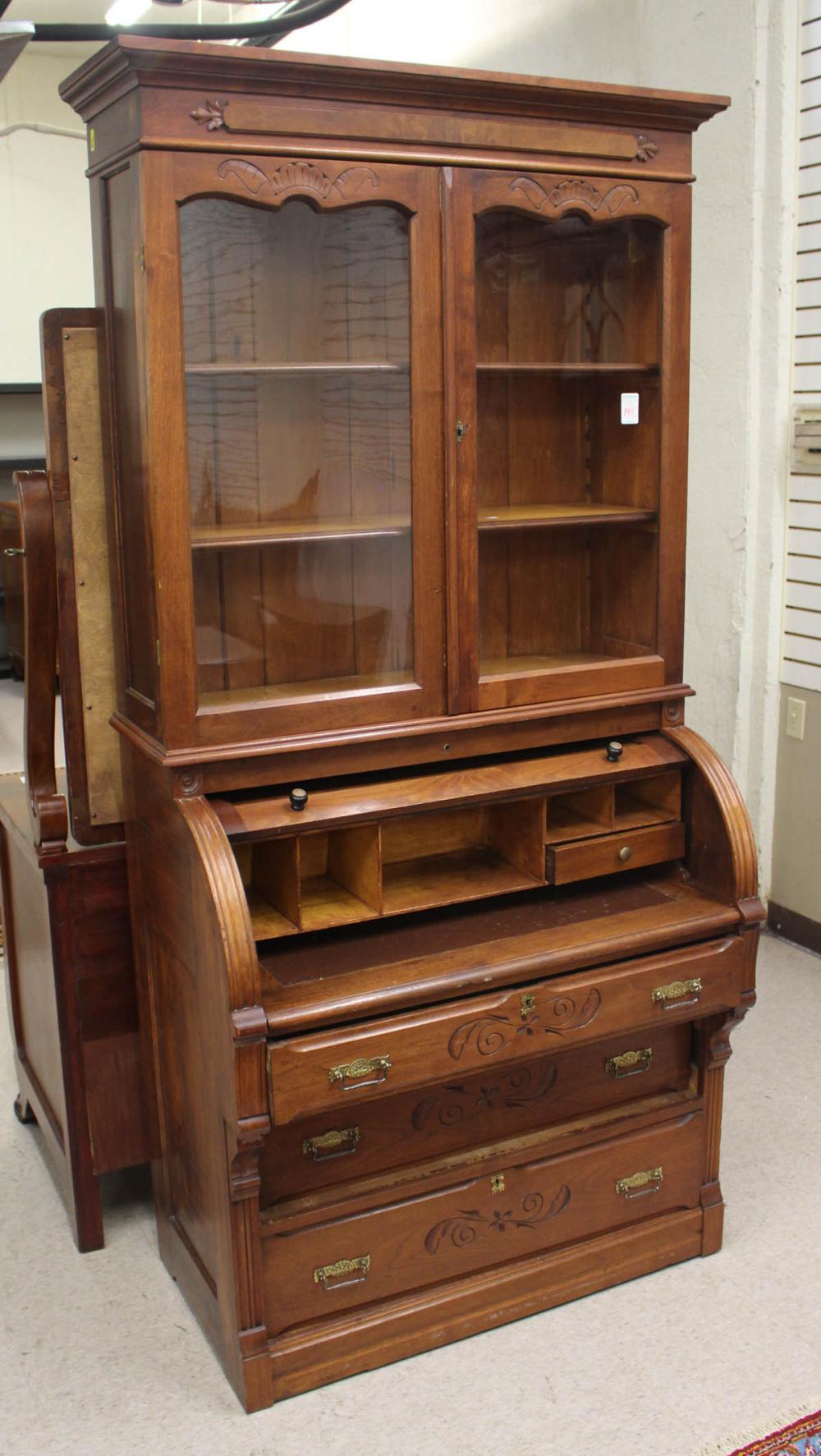 Appraisal: VICTORIAN WALNUT CYLINDER-ROLL SECRETARY BOOKCASE Eastlake design American c in