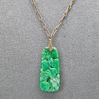 Appraisal: JADE PENDANT ON K GOLD CHAIN Carved green jade pendant