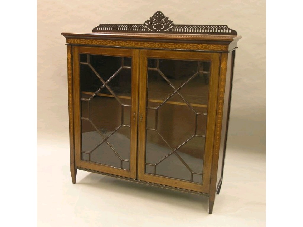 Appraisal: An Edwardian inlaid mahogany display cabinet raised back with carved