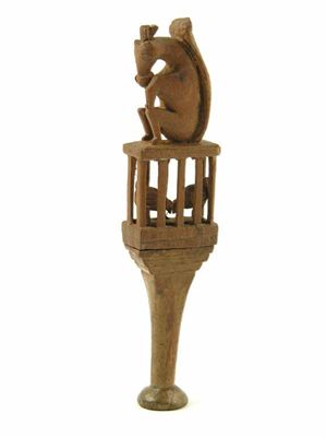 Appraisal: An th century carved treen pipe tamper with a squirrel