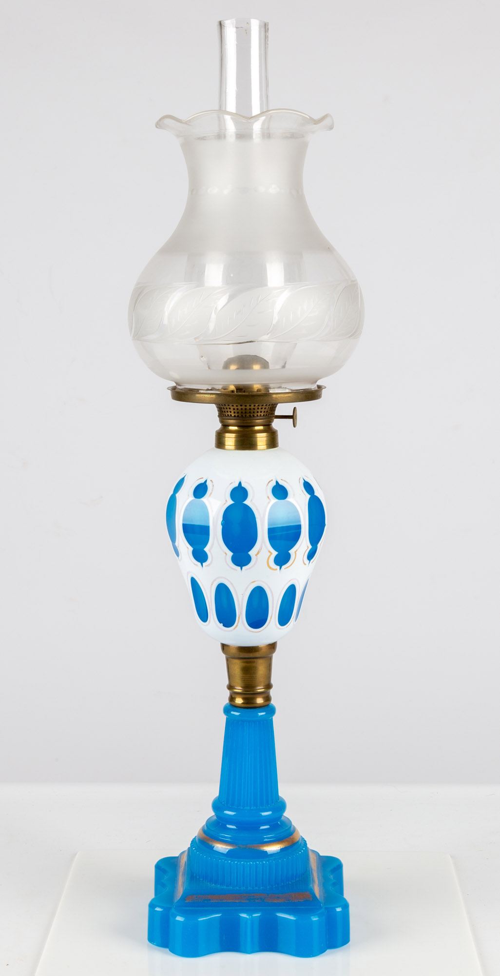 Appraisal: WHITE CUT TO BLUE OVERLAY OIL LAMP circa White overlay