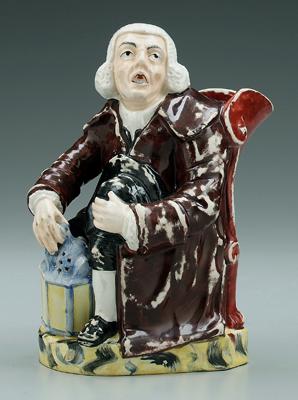 Appraisal: Toby jug seated gentleman holding blue lantern spout in back