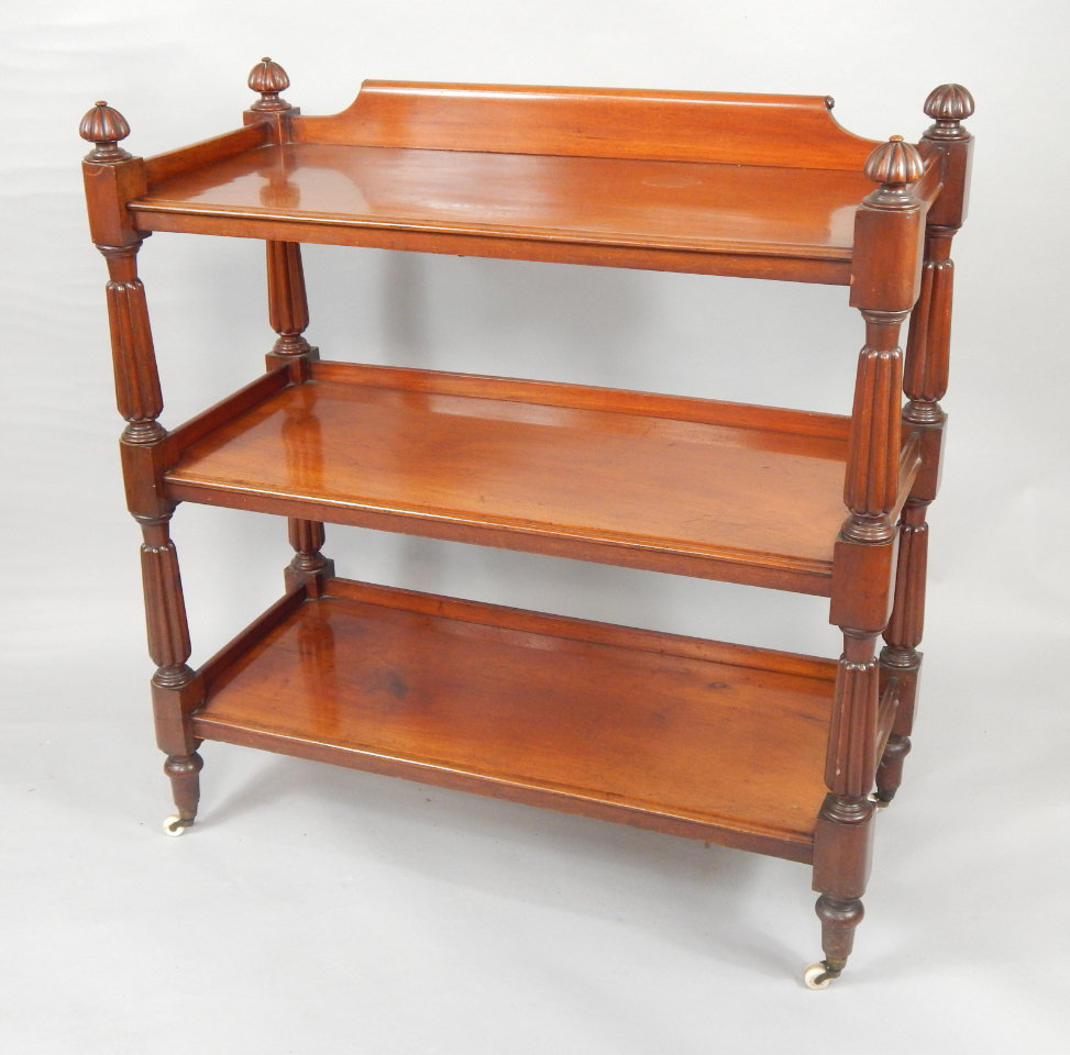 Appraisal: A Victorian mahogany three tier buffet raised on fluted and