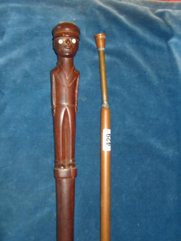 Appraisal: A walking cane with carved and painted decoration of a