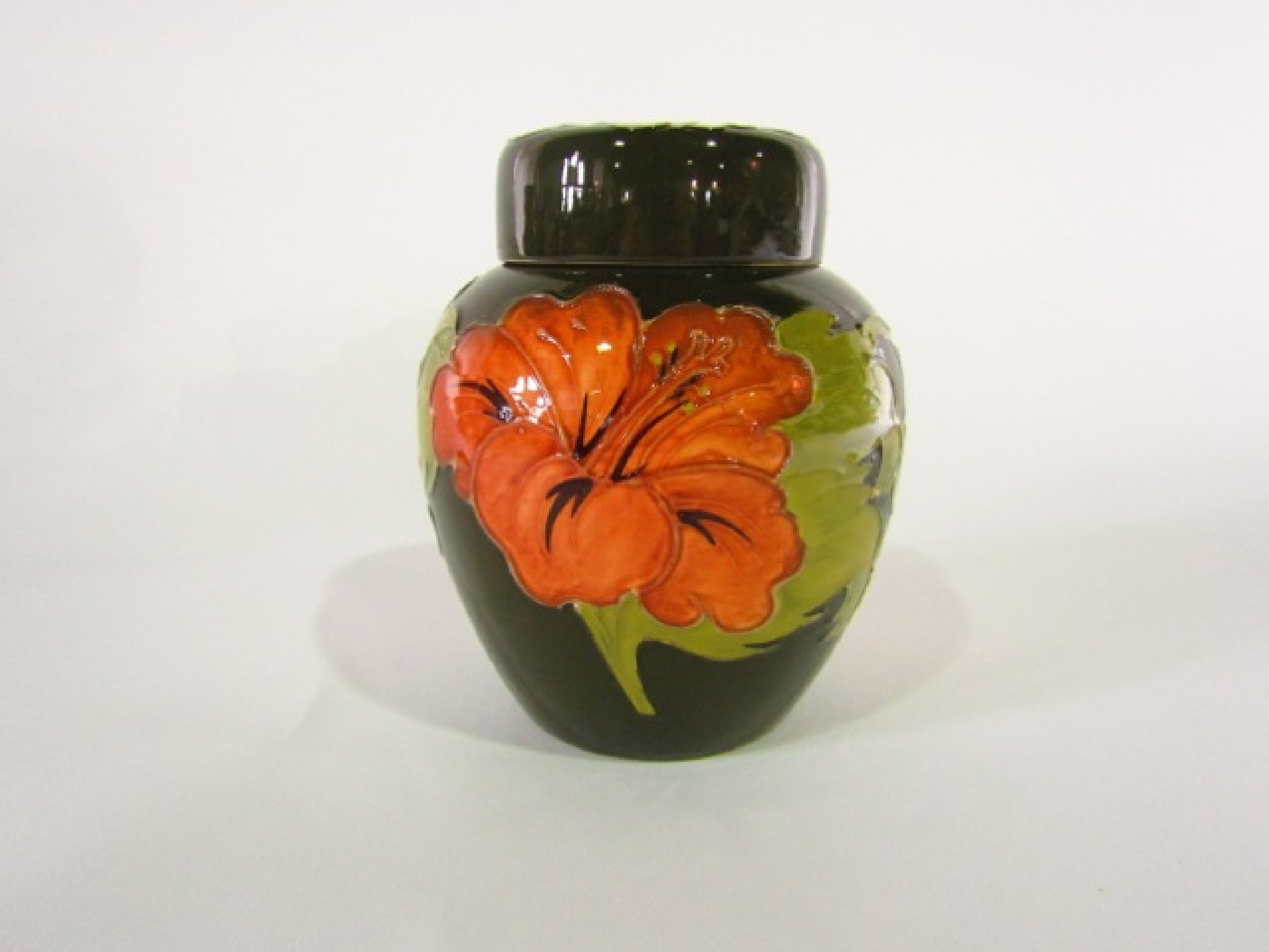 Appraisal: A Moorcroft green ground ginger jar and cover in the