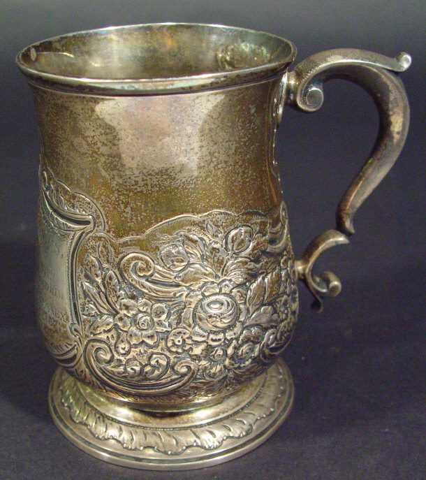 Appraisal: Georgian silver tankard with inscription embossed with flowers to the