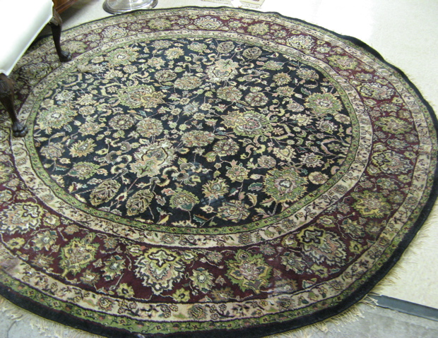 Appraisal: ROUND ORIENTAL CARPET Indo-Persian overall floral design across the black