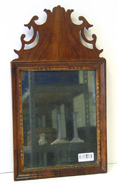 Appraisal: A Continental walnut small mirror second half th century The