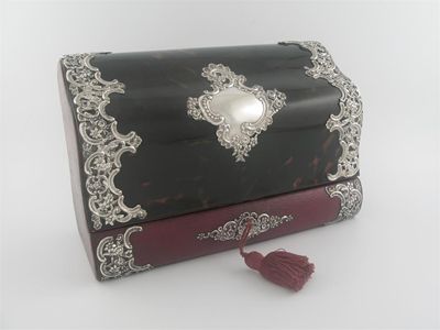 Appraisal: An Edwardian bombe mounted tortoiseshell and red leather stationery box