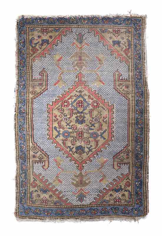 Appraisal: A Northwest Persian Wool Rug having a central geometric lozenge