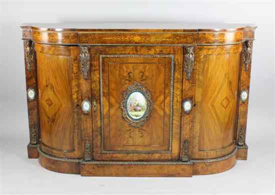 Appraisal: A Victorian marquetry inlaid walnut credenza inset with five Sevres