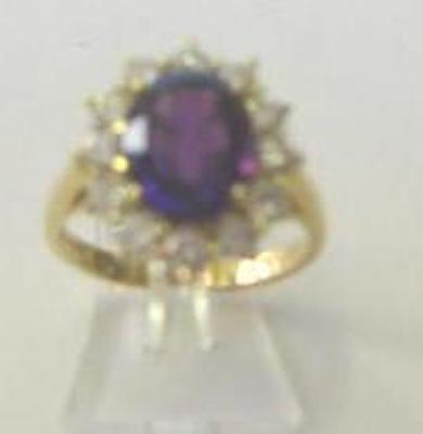 Appraisal: AN AMETHYST AND DIAMOND CLUSTER RING the oval cut amethyst