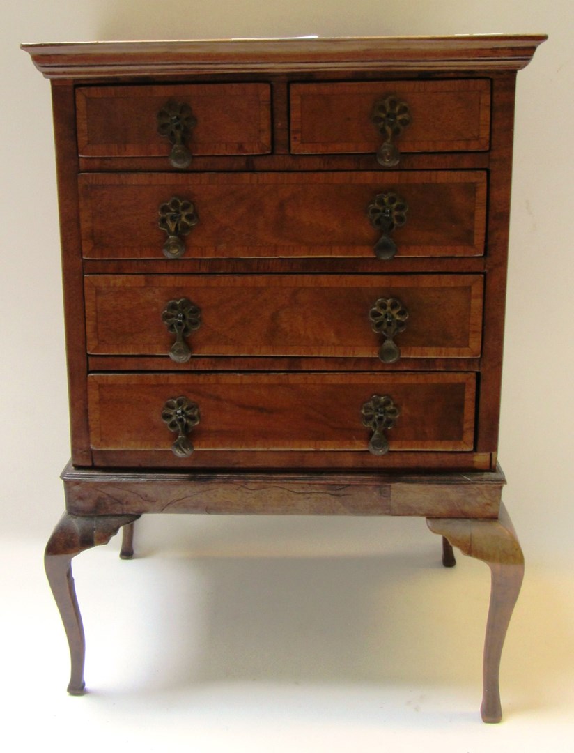 Appraisal: A miniature walnut chest on stand of early th century