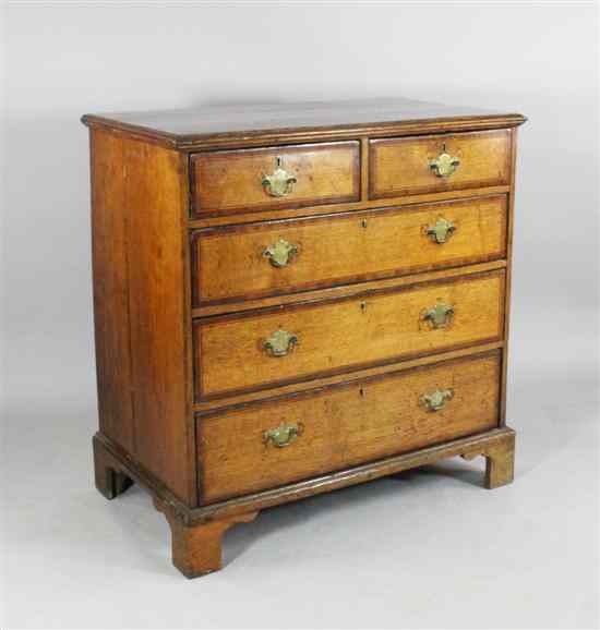 Appraisal: A mid th century inlaid oak chest with two short