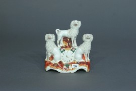 Appraisal: A Staffordshire figure of three poodles with a clock face