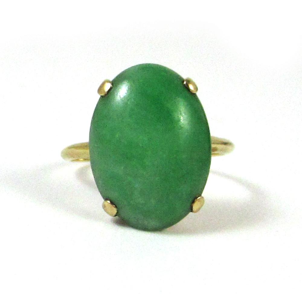 Appraisal: GREEN JADE AND FOURTEEN KARAT GOLD RING with four yellow