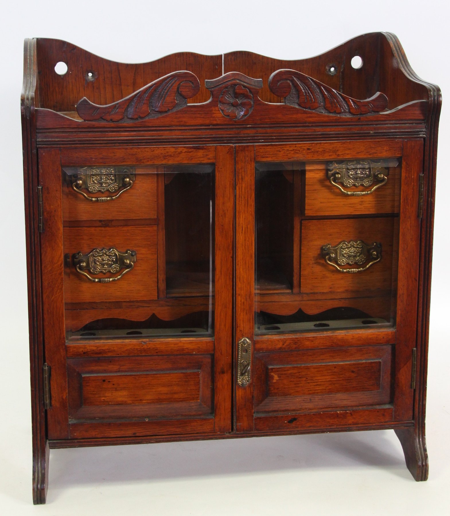 Appraisal: An Edwardian walnut smokers compendium enclosed by a pair of