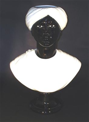 Appraisal: A Fornasetti Blackamoor ceramic bust on black socle with red