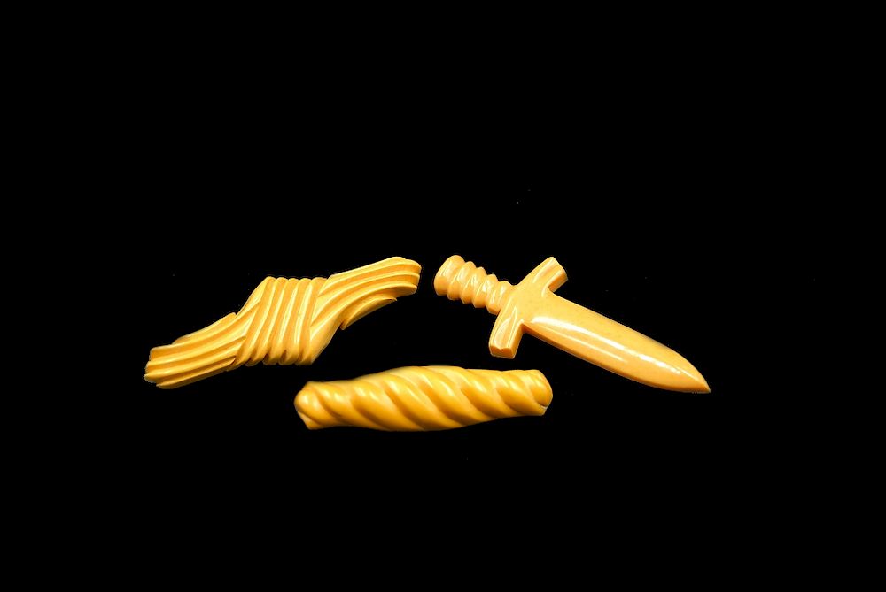 Appraisal: Carved Bakelite Pins Sword All Caramel Carved Bakelite Pins Sword