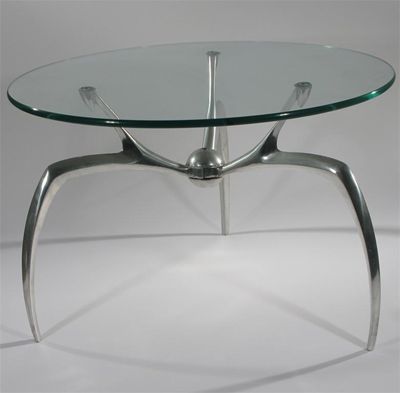 Appraisal: A polished aluminium and glass table in the manner of