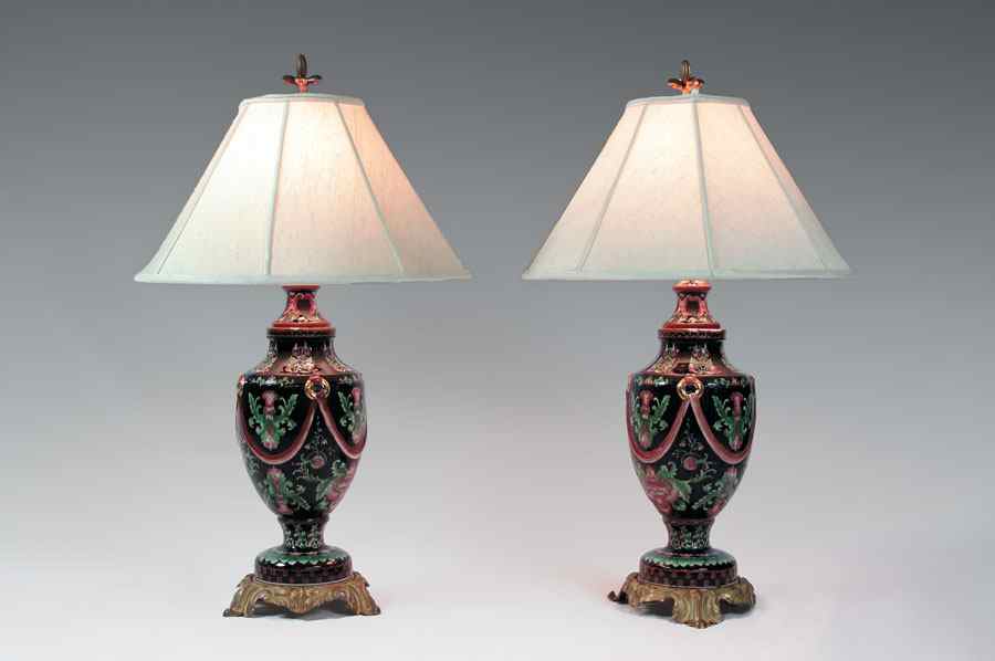 Appraisal: PAIR OF FAMILLE NOIR STYLE LAMPS Porcelain urn lamps painted