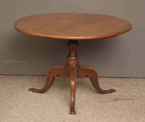 Appraisal: A th Century oak circular tripod table on turned centre