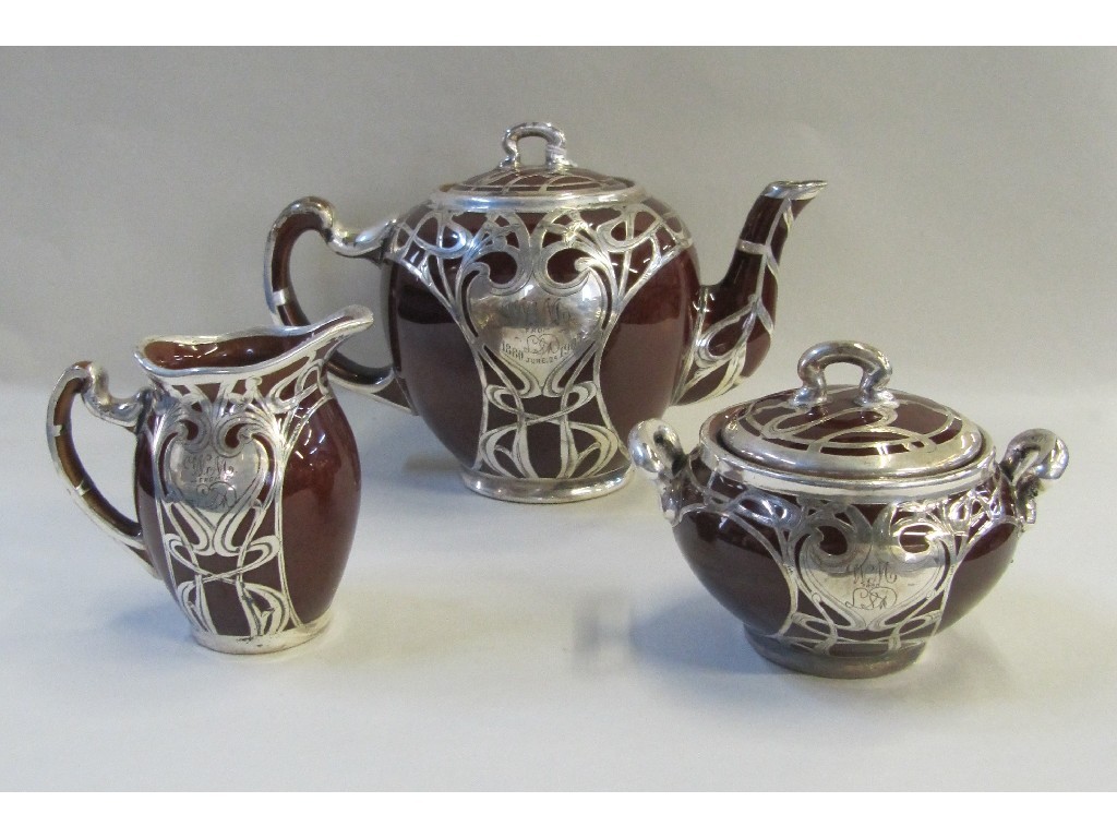 Appraisal: Brown glazed Lennox three piece teaset with overlaid silver Art