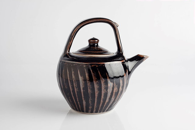 Appraisal: Derek Emms British - Teapottenmoku glaze and facetted sidesimpressed potter's