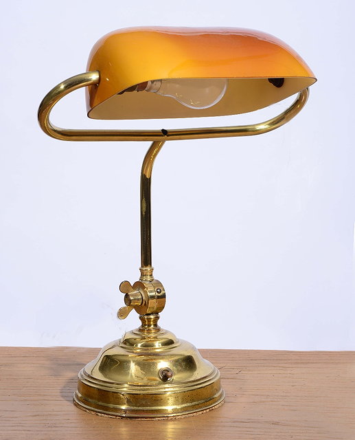 Appraisal: A BRASS STUDENTS LAMP with glass shade and circular base